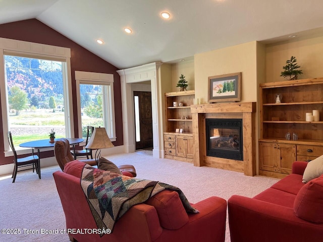 96 Hardman Rd, Star Valley Ranch, WY 83127 - living area with a glass covered fireplace, carpet floors, recessed lighting, and vaulted ceiling