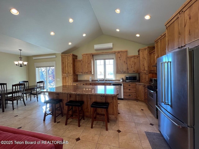 96 Hardman Rd, Star Valley Ranch, WY 83127 - kitchen with appliances with stainless steel finishes, a wall unit AC, a sink, a kitchen island, and a chandelier