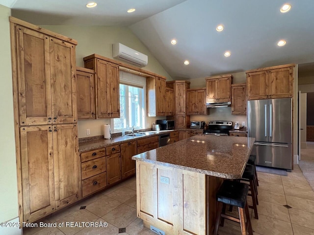96 Hardman Rd, Star Valley Ranch, WY 83127 - kitchen with appliances with stainless steel finishes, a wall mounted air conditioner, under cabinet range hood, vaulted ceiling, and light tile patterned floors