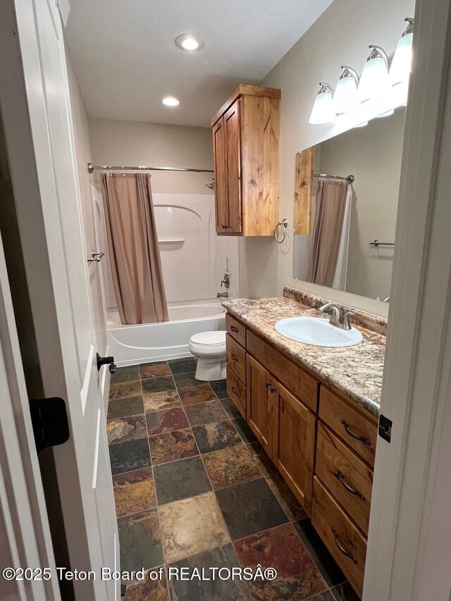96 Hardman Rd, Star Valley Ranch, WY 83127 - full bathroom with stone tile floors, vanity, shower / bath combo with shower curtain, toilet, and recessed lighting