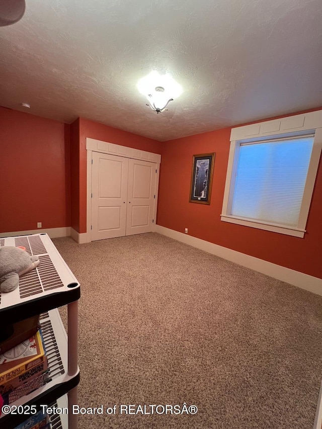 96 Hardman Rd, Star Valley Ranch, WY 83127 - unfurnished bedroom featuring a textured ceiling, carpet, a closet, and baseboards