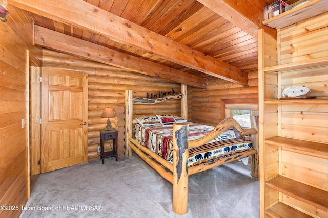 185 River Bench Rd, Thayne, WY 83127 - bedroom with wooden ceiling, beam ceiling, log walls, and carpet flooring