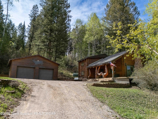 185 River Bench Rd, Thayne, WY 83127 - view of front of house featuring a detached garage, an outbuilding, and a porch
