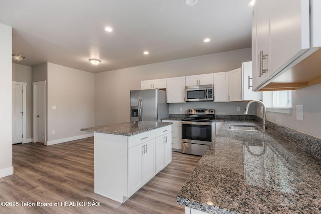 68 Alpine Trl Unit 38, Victor, ID 83455 - kitchen featuring stainless steel appliances, a sink, a center island, dark stone counters, and recessed lighting