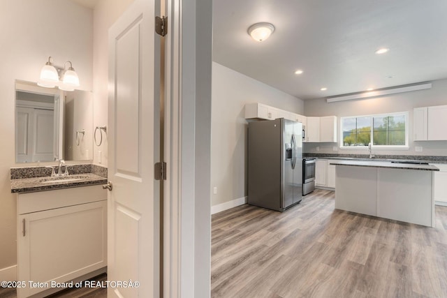 68 Alpine Trl Unit 38, Victor, ID 83455 - kitchen with stainless steel appliances, a sink, light wood-type flooring, white cabinetry, and recessed lighting