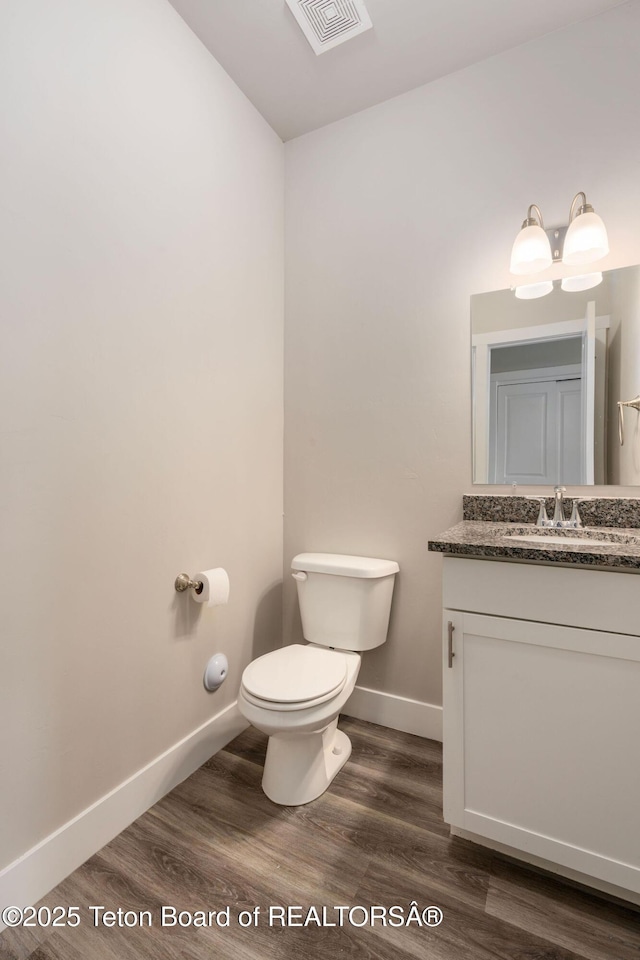 68 Alpine Trl Unit 38, Victor, ID 83455 - bathroom featuring toilet, wood finished floors, vanity, and baseboards