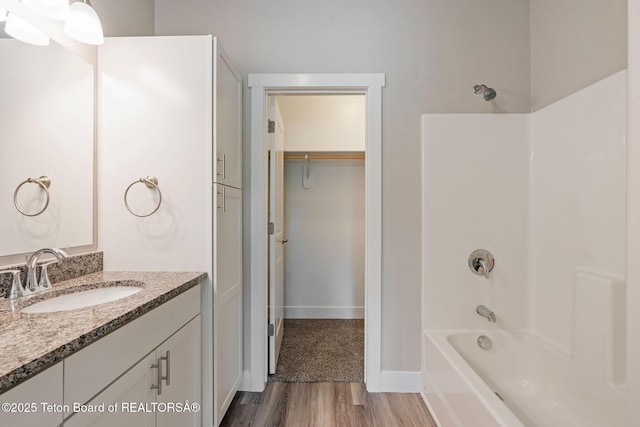 68 Alpine Trl Unit 38, Victor, ID 83455 - full bath featuring wood finished floors, vanity, bathing tub / shower combination, a walk in closet, and baseboards