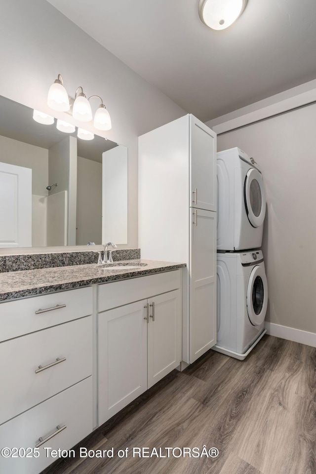 68 Alpine Trl Unit 38, Victor, ID 83455 - bathroom with stacked washer and clothes dryer, wood finished floors, vanity, and baseboards