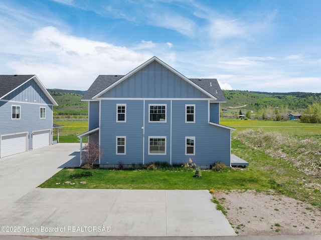 68 Alpine Trl Unit 38, Victor, ID 83455 - view of home's exterior with board and batten siding, a lawn, a garage, and concrete driveway