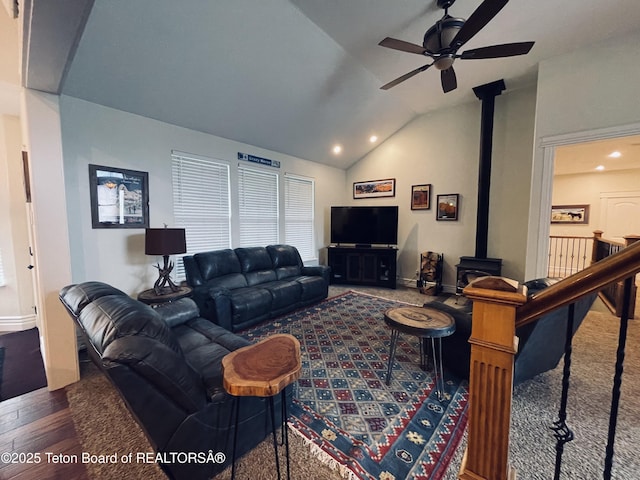 61 Astorian Ln, Smoot, WY 83126 - living room featuring a ceiling fan, lofted ceiling, a wood stove, wood finished floors, and baseboards