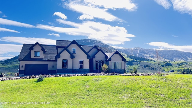 61 Astorian Ln, Smoot, WY 83126 - view of front of property featuring a mountain view, a garage, a front lawn, and roof with shingles