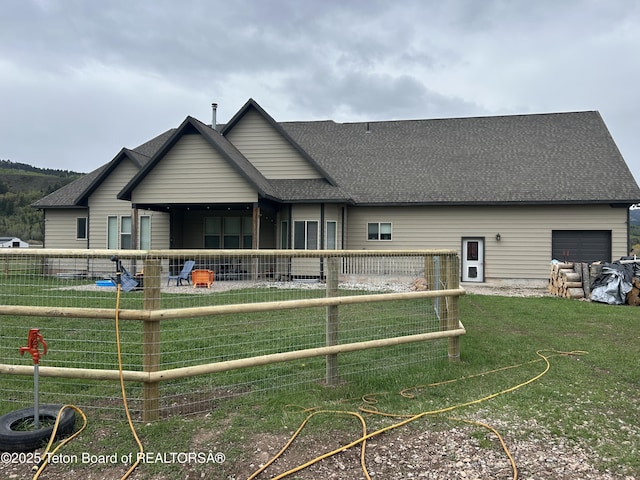 61 Astorian Ln, Smoot, WY 83126 - rear view of property featuring roof with shingles and an attached garage