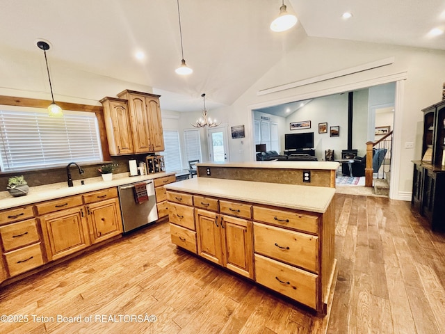 61 Astorian Ln, Smoot, WY 83126 - kitchen with stainless steel dishwasher, light wood-style flooring, lofted ceiling, a chandelier, and light countertops