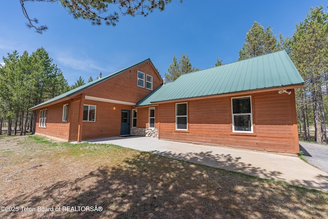 4515 Weslin Trl, Island Park, ID 83429 - back of house with a patio area and metal roof
