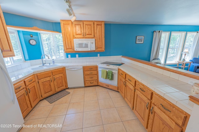 4515 Weslin Trl, Island Park, ID 83429 - kitchen with white appliances, a sink, tile countertops, a peninsula, and light tile patterned flooring