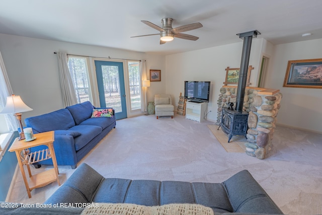 4515 Weslin Trl, Island Park, ID 83429 - living room featuring a wood stove, carpet, and a ceiling fan