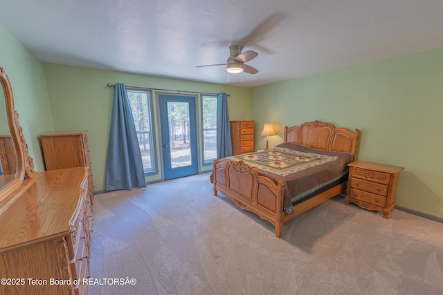 4515 Weslin Trl, Island Park, ID 83429 - bedroom featuring access to exterior, light colored carpet, ceiling fan, and baseboards