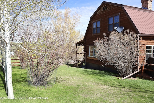31 Cutoff Rd, Daniel, WY 83115 - view of side of home with metal roof, a chimney, a lawn, and log exterior