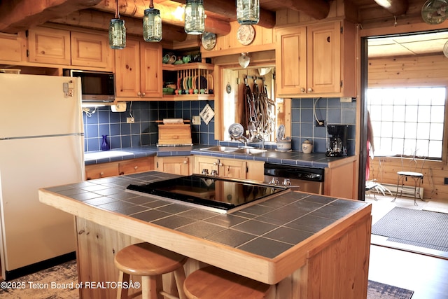 31 Cutoff Rd, Daniel, WY 83115 - kitchen with freestanding refrigerator, tile countertops, dishwasher, built in microwave, and a sink