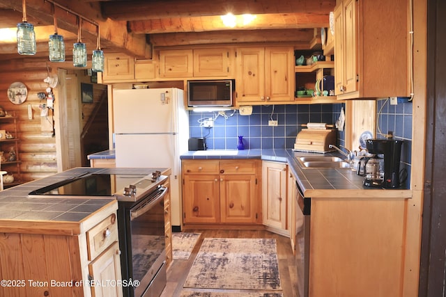 31 Cutoff Rd, Daniel, WY 83115 - kitchen featuring tile countertops, stainless steel appliances, log walls, light wood finished floors, and backsplash