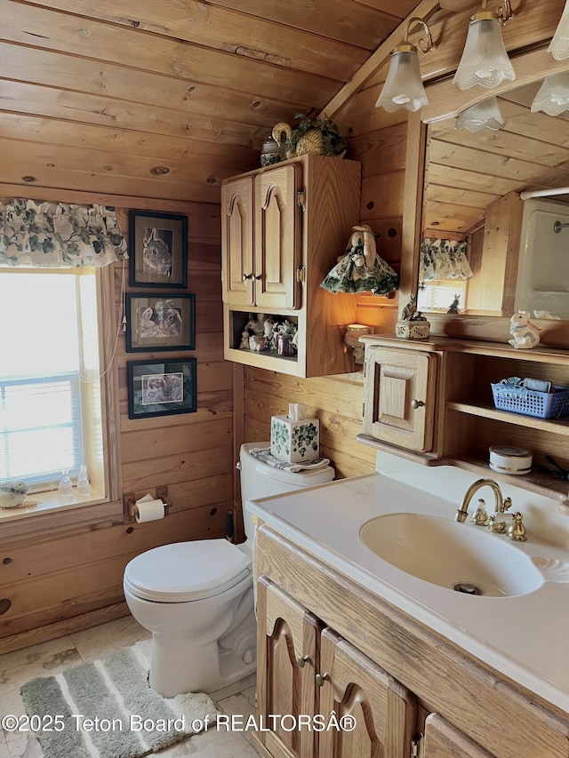31 Cutoff Rd, Daniel, WY 83115 - bathroom featuring wood ceiling, vanity, toilet, wood walls, and tile patterned flooring