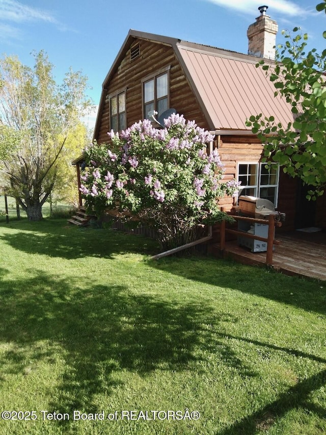 31 Cutoff Rd, Daniel, WY 83115 - view of side of home with a wooden deck, a chimney, a lawn, and metal roof