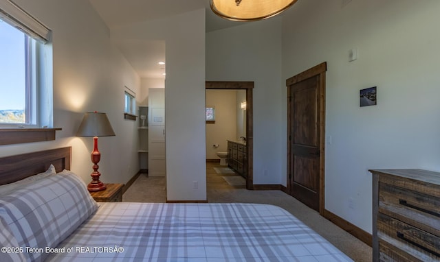 8494 Pronghorn Trl, Victor, ID 83455 - bedroom with carpet flooring, baseboards, and connected bathroom