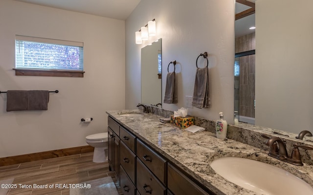 8494 Pronghorn Trl, Victor, ID 83455 - full bathroom with wood finish floors, healthy amount of natural light, toilet, and baseboards