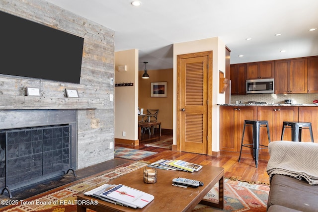 3670 W Michael Dr Unit E-21-E, Teton Village, WY 83025 - living room with wood finished floors, a stone fireplace, recessed lighting, and baseboards