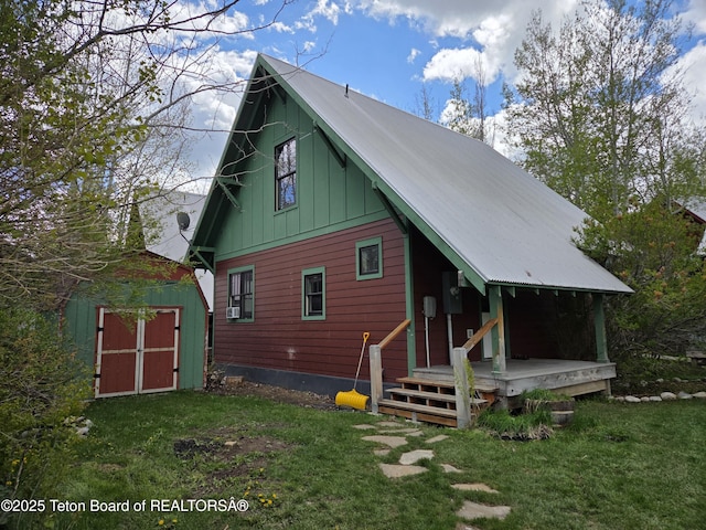 9064 Village Way, Victor, ID 83455 - back of property with a yard, metal roof, and board and batten siding