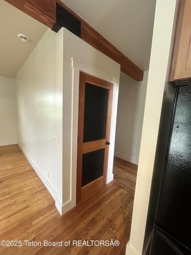 9064 Village Way, Victor, ID 83455 - hallway with light wood-type flooring, vaulted ceiling, and baseboards