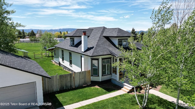 366 E 5th Ave, Afton, WY 83110 - view of front facade with a mountain view, a chimney, and roof with shingles