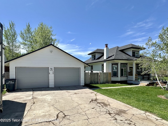 366 E 5th Ave, Afton, WY 83110 - view of front of home with a chimney, roof with shingles, and a detached garage