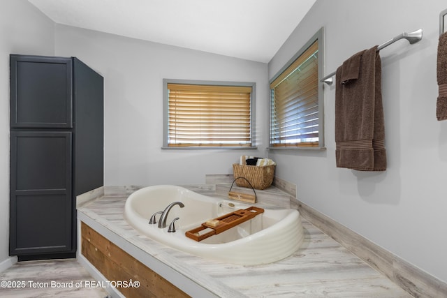 366 E 5th Ave, Afton, WY 83110 - full bath featuring a jetted tub, vaulted ceiling, and wood finished floors