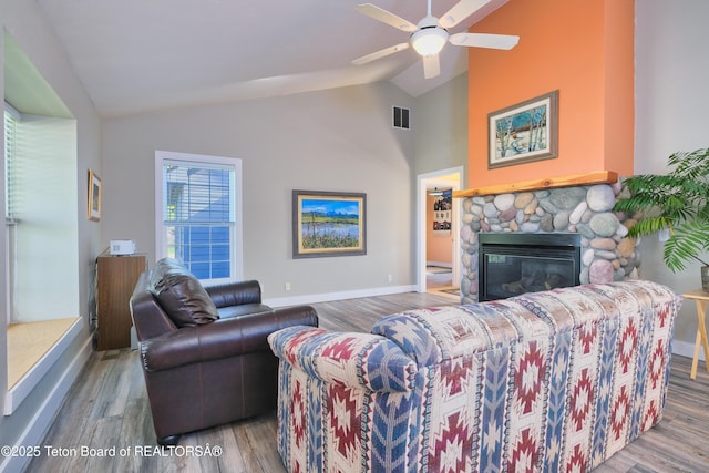 2697 Rendezvous Dr, Driggs, ID 83422 - living room featuring baseboards, a fireplace, ceiling fan, wood finished floors, and high vaulted ceiling