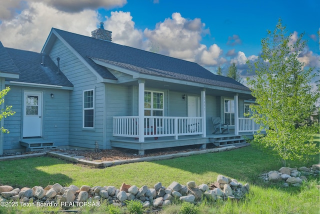 2697 Rendezvous Dr, Driggs, ID 83422 - back of property featuring a chimney, a yard, a porch, and a shingled roof