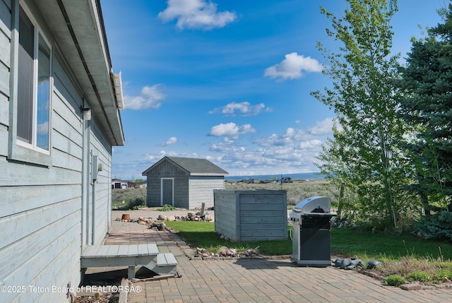 2697 Rendezvous Dr, Driggs, ID 83422 - deck featuring a patio area, an outbuilding, and grilling area