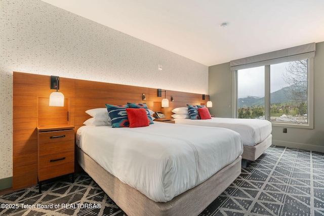 3335 W Villlage Dr Unit 201/203, Teton Village, WY 83025 - bedroom featuring baseboards, a mountain view, dark floors, and vaulted ceiling