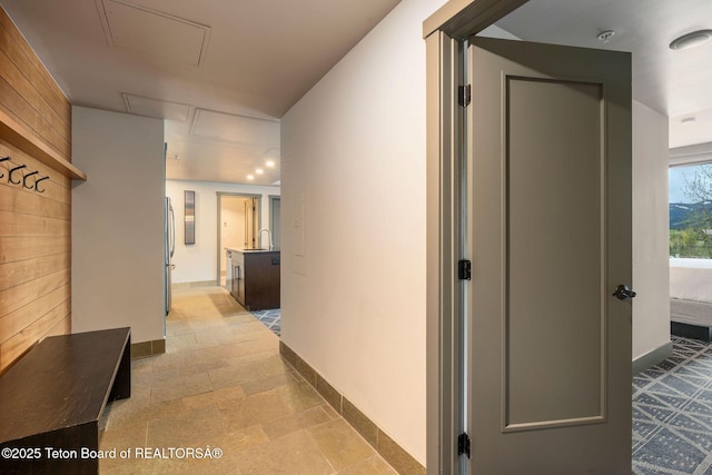 3335 W Villlage Dr Unit 201/203, Teton Village, WY 83025 - hallway featuring attic access, baseboards, and a sink
