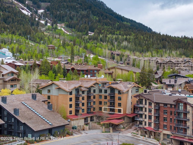 3335 W Villlage Dr Unit 201/203, Teton Village, WY 83025 - drone / aerial view of a heavily wooded area and a mountain backdrop