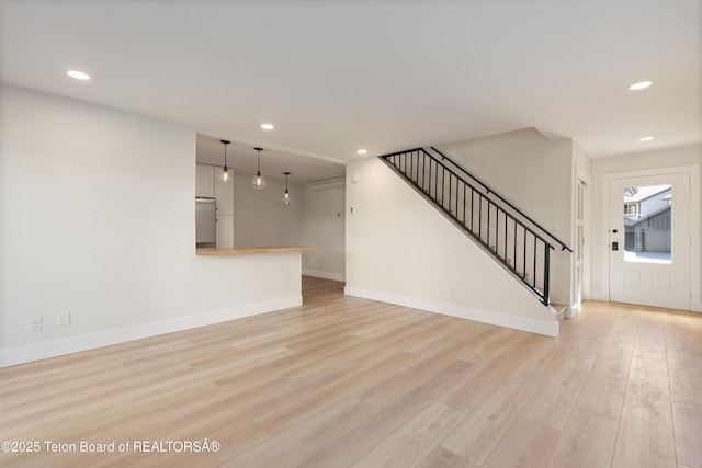 826 Powderhorn Ln Unit C, Jackson, WY 83001 - unfurnished living room with recessed lighting, light wood-type flooring, stairway, and baseboards