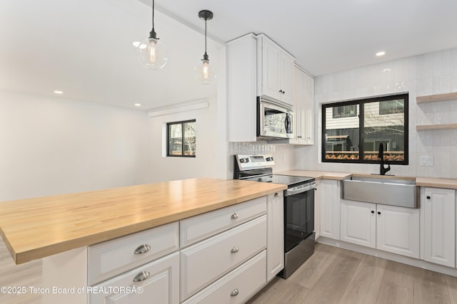 826 Powderhorn Ln Unit C, Jackson, WY 83001 - kitchen featuring stainless steel appliances, a sink, wooden counters, light wood-style flooring, and recessed lighting