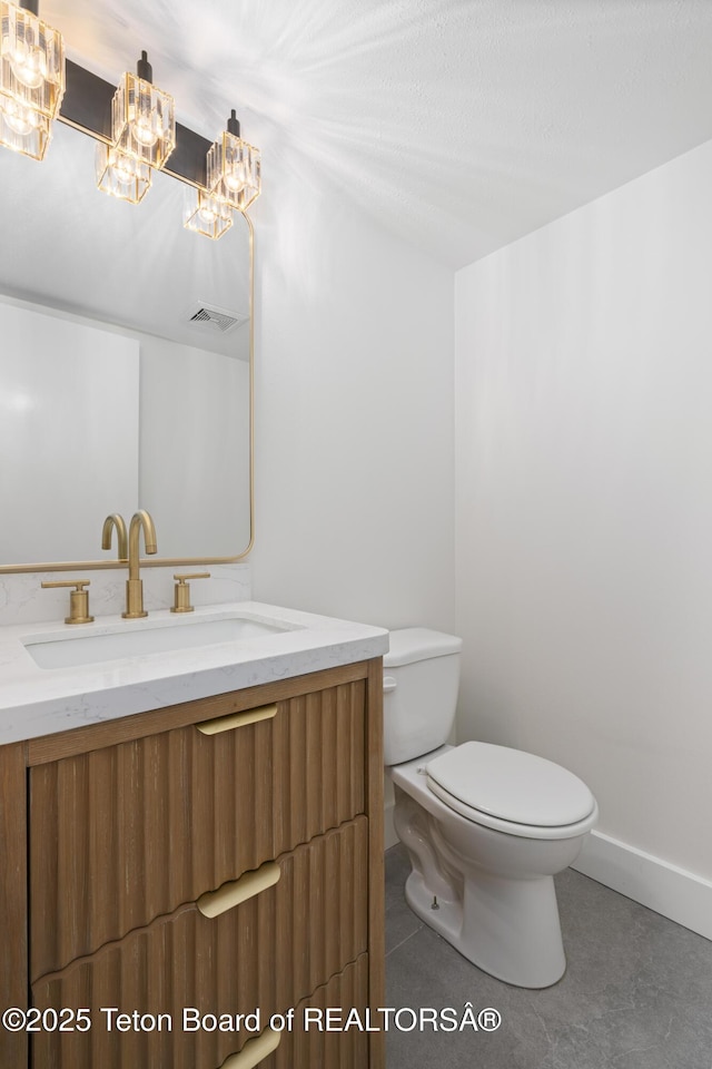 826 Powderhorn Ln Unit C, Jackson, WY 83001 - bathroom featuring toilet, vanity, a chandelier, and baseboards