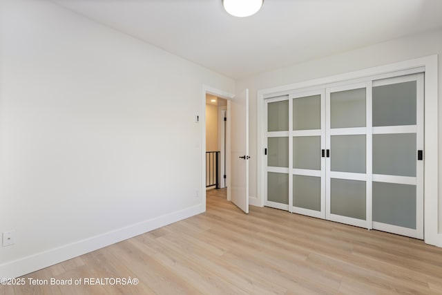 826 Powderhorn Ln Unit C, Jackson, WY 83001 - unfurnished bedroom featuring light wood-type flooring and baseboards