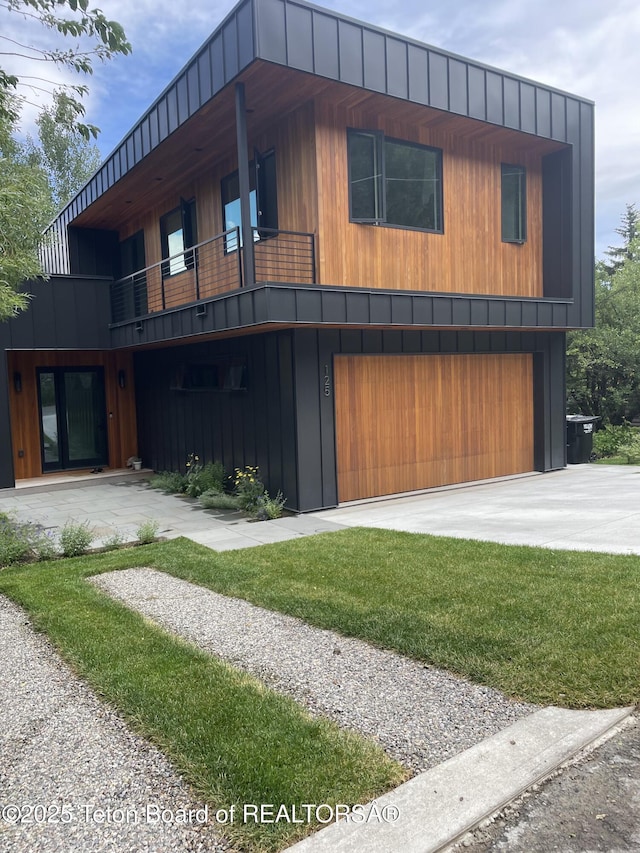 125 Pine Dr, Jackson, WY 83001 - modern home with a balcony, an attached garage, and driveway