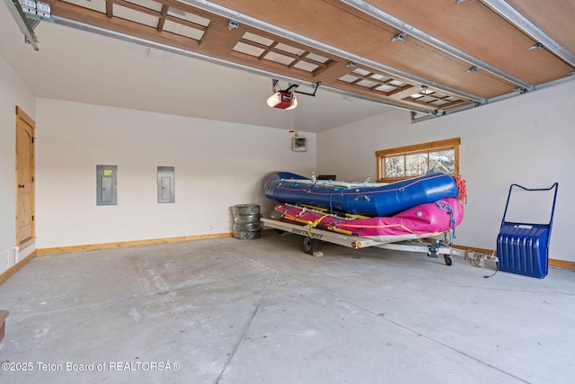 19 Moulton Ln, Victor, ID 83422 - garage with electric panel, a garage door opener, and baseboards