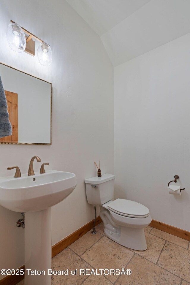 19 Moulton Ln, Victor, ID 83422 - bathroom with baseboards, toilet, lofted ceiling, and a sink