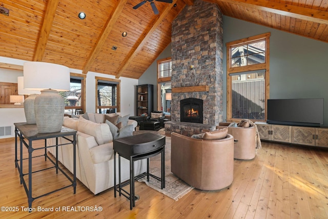 19 Moulton Ln, Victor, ID 83422 - living area with wood ceiling with exposed beams, hardwood / wood-style flooring, a stone fireplace, a ceiling fan, and high vaulted ceiling
