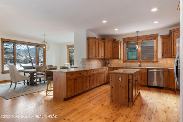 19 Moulton Ln, Victor, ID 83422 - kitchen featuring stainless steel dishwasher, a kitchen breakfast bar, plenty of natural light, light wood finished floors, and recessed lighting