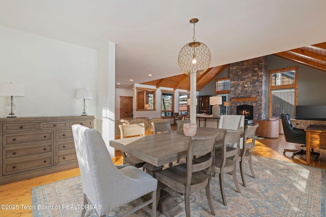 19 Moulton Ln, Victor, ID 83422 - dining area with light wood-style floors, a stone fireplace, vaulted ceiling, and recessed lighting